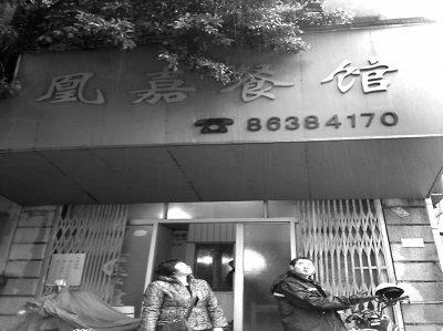 洪鳳媚站在自家店門口，看著“凰嘉餐館”4個(gè)字黯然