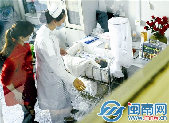 志愿者和護士在病房內(nèi)照顧寶寶
