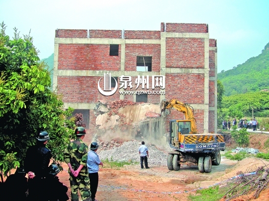 挖掘機(jī)對違建別墅進(jìn)行破除