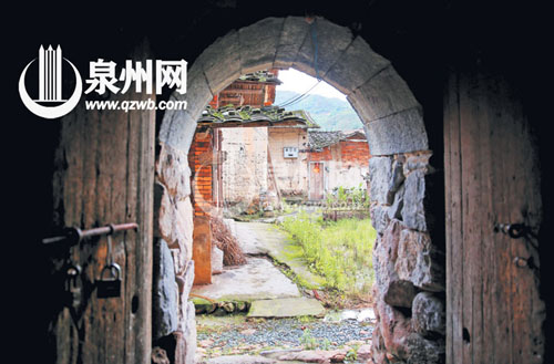 這一石拱門是土樓的邊門，對面是土樓的配套古厝。